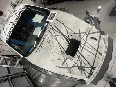 White Porsche 935 rear with PORSCHE lettering and black abstract line livery
