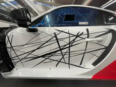 White Porsche 935 door and side with black scratch-line motorsport livery graphics