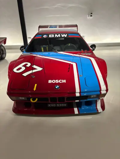 Red BMW M1 Procar number 67 front view with blue stripe race livery