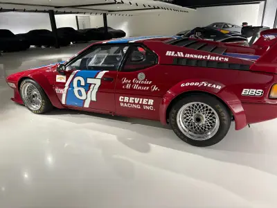Side of red BMW M1 Procar number 67, Crevier Racing and RLM Associates livery