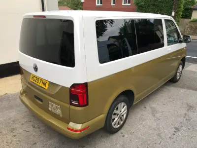 Rear of a white-over-olive VW Transporter van with a greenhouse line-drawing graphic, plate HG20 FHK