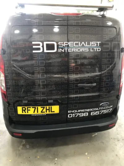 Rear of black Ford Transit Custom with 3D Specialist Interiors Ltd part wrap