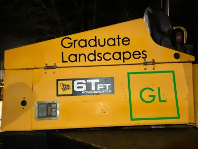 Yellow JCB 6TFT dumper with black Graduate Landscapes text and green GL logo