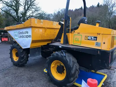 Yellow JCB 6TFT site dumper with Graduate Landscapes graphics on skip and body