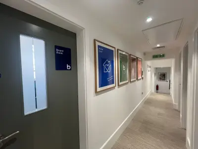 Bluebird Care office corridor with framed care-service posters and a Board Room door sign