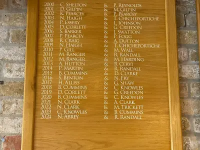 Engraved oak honours board listing pairs winners 2000 to 2024 in gold lettering