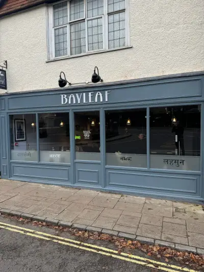 Close view of the 'Bayleaf' Indian restaurant fascia sign and Hindi window graphics