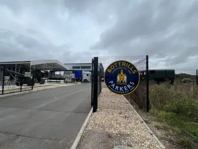 Bottrills Parkers roundel sign on a fence at an industrial haulage yard entrance