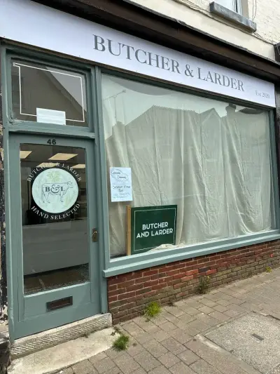 Butcher & Larder shopfront fascia sign with hand-selected cow logo on the door