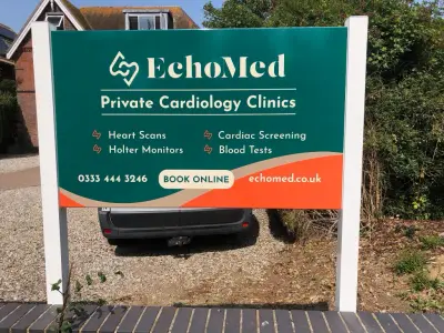 Green and orange EchoMed Private Cardiology Clinics post-mounted forecourt signboard