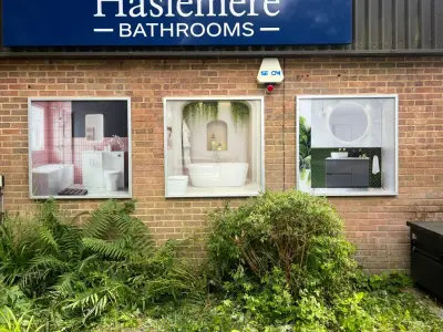 Haslemere Bathrooms external display panels showing bathroom scenes on a brick wall