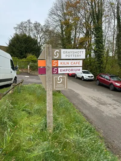 Grayshott Pottery, Kiln Cafe and Emporium directional fingerpost sign on a verge