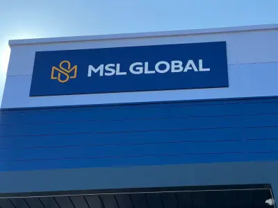 Close-up of navy MSL Global fascia sign with yellow logo on a blue building