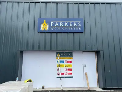 Parkers of Chichester fascia sign and site safety rules board above a warehouse door