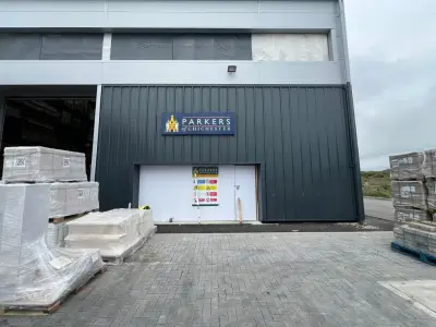 Parkers of Chichester fascia sign above a warehouse entrance with stacked pallets