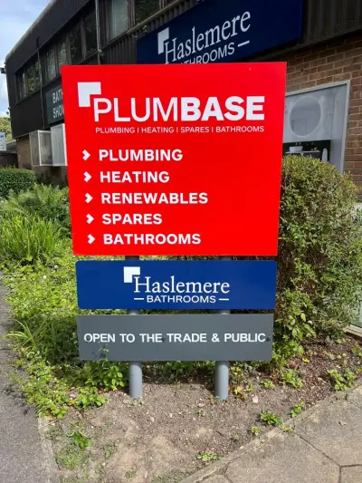 Red Plumbase and blue Haslemere Bathrooms post-mounted roadside totem signboard