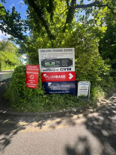 Unicorn Trading Estate roadside directory sign listing Plumbase and Haslemere Bathrooms