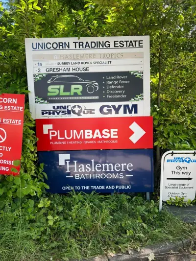 Unicorn Trading Estate multi-business directory signboard among greenery