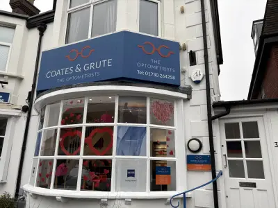 Coates & Grute Optometrists blue wraparound fascia sign and Valentine's window graphics