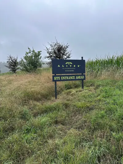 Alitex Glasshouses navy Site Entrance Ahead post-mounted board in rough grass