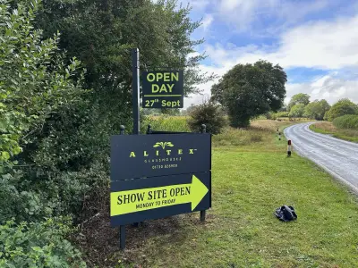 Alitex Glasshouses site board with Open Day sign and Show Site Open arrow beside a hedge