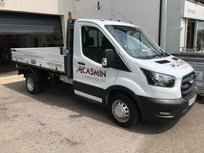 Casmin Construction Ltd white Ford tipper truck with door and dropside signwriting