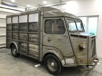 Vintage Citroen H van with IWC Schaffhausen Silver Spitfire door graphics in a workshop