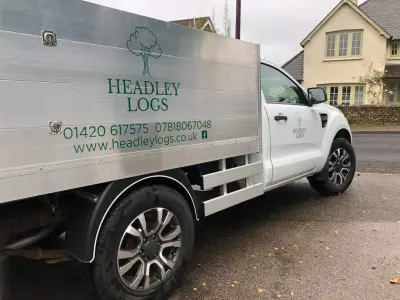 Silver Ford Ranger dropside tipper with green Headley Logs tree logo and signwriting