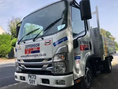 Silver Isuzu Jefferson Gas flatbed cab with Calor, Campingaz and Primus front branding