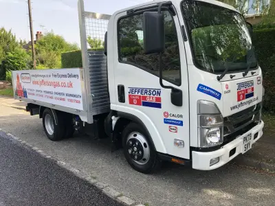 White Isuzu N-series Jefferson Gas flatbed with Calor branding parked kerbside