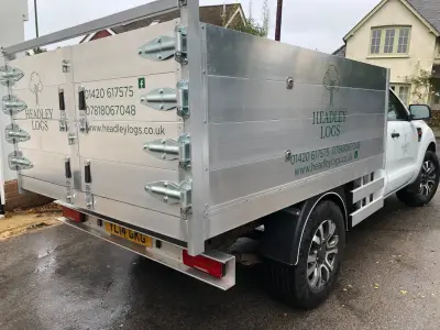 White Ford Ranger tipper with aluminium sides, signwritten in green for Headley Logs