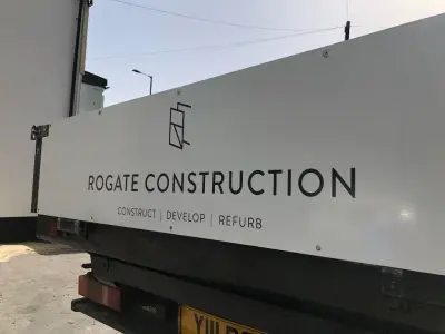 White truck bodywork with black Rogate Construction signwriting, Construct Develop Refurb