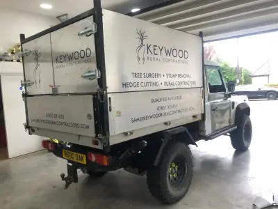 White Land Rover Defender pickup with Keywood Rural Contractors signwriting, tree surgery