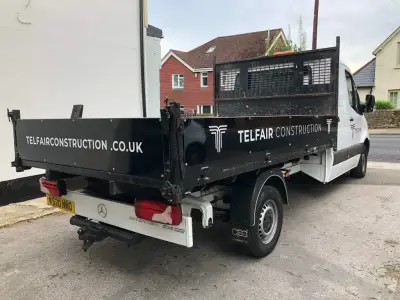 White Mercedes Sprinter dropside tipper with black Telfair Construction body graphics