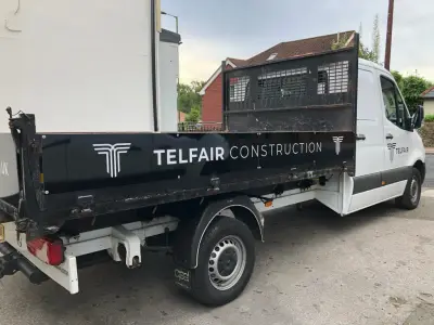 White Mercedes Sprinter tipper with black Telfair Construction side and cab graphics