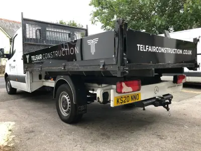 Rear of white Mercedes Sprinter tipper with black Telfair Construction tailgate graphics