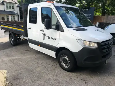 White Mercedes Sprinter double-cab tipper with grey Telfair Construction cab graphics