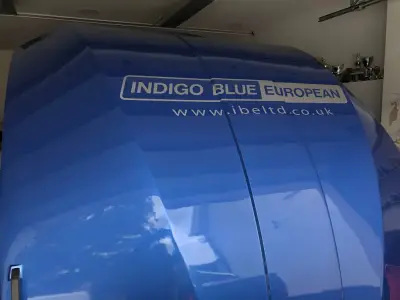 Blue trailer front panel with white Indigo Blue European logo and website graphics