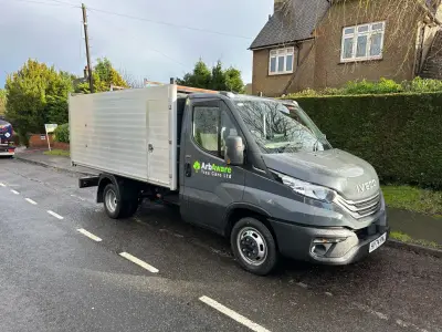 Grey Iveco Daily tipper truck with green ArbAware Tree Care Ltd door signwriting