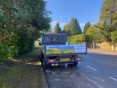 White Ford Transit tipper rear with Southdowns Builders Ltd landscape graphic and phone numbers