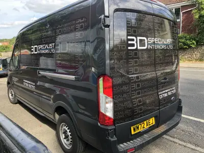 Black Ford Transit van wrapped with repeating 3D Specialist Interiors Ltd branding, rear corner view, reg WM72 AEJ