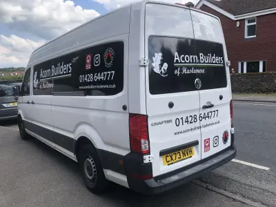 White VW Crafter van with black side panel graphics for Acorn Builders of Haslemere, reg CX73 NVH