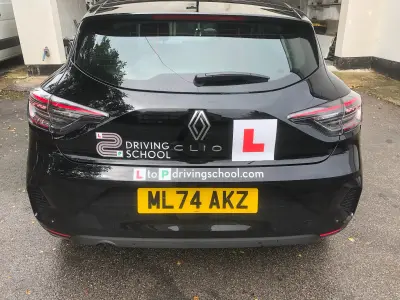 Black Renault Clio rear with L2P Driving School graphics and L-plate, reg ML74 AKZ