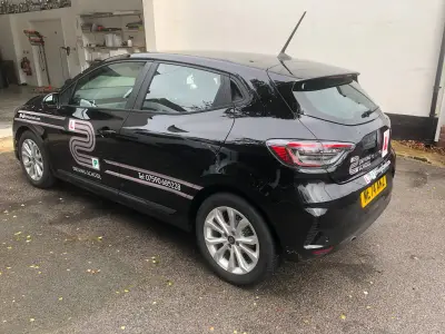 Black Renault Clio with L2P Driving School side and rear graphics, three-quarter view