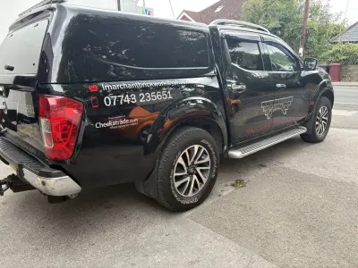Black Nissan Navara pickup with canopy, L. Marchant Brickwork Ltd graphics and Checkatrade logo