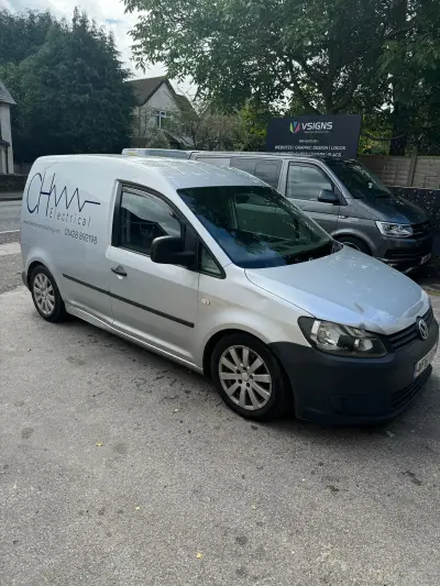 Silver Volkswagen Caddy van with CH Electrical signwriting outside the VSIGNS premises