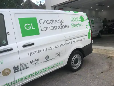 White Mercedes eVito electric van with green Graduate Landscapes livery, side view