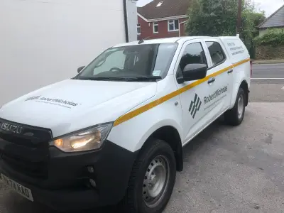 White Isuzu D-Max pickup with Robert Nicholas Civil Engineering graphics and yellow reflective stripe
