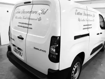 White Citroen Berlingo van with black Eaton Decorators Ltd signwriting, rear three-quarter view