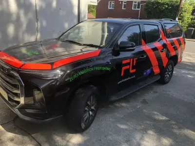 Black and red First Line pickup with Zero Emission Firefighting FL wrap, side view